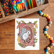 Load image into Gallery viewer, Coloring page with a squirrel illustration on a wooden surface with markers and beads.