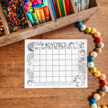 Load image into Gallery viewer, November calendar coloring page on a wooden surface with markers and beads.