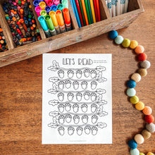 Load image into Gallery viewer, Colorful markers in a wooden box with a coloring sheet titled 'Let's Read' on a wooden surface.