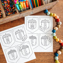 Load image into Gallery viewer, Colorful markers in a wooden box with November banner coloring sheets on a wooden surface.
