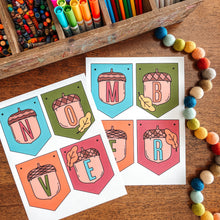 Load image into Gallery viewer, Colorful markers in a wooden box with November banner on a wooden surface