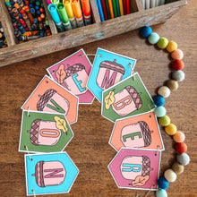 Load image into Gallery viewer, Colorful November banner on a wooden surface with art supplies in the background