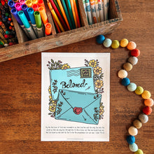 Load image into Gallery viewer, Colorful stationery items including pens, markers, and a coloring page with 'Beloved' on a wooden surface.