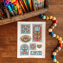 Load image into Gallery viewer, Colorful stationery items including markers, pencils, and a decorative stamp art print on a wooden surface.