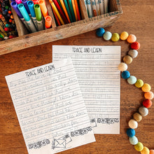 Load image into Gallery viewer, Colorful markers, pencils, and a 'Trace and Learn' worksheet on a wooden surface.
