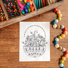 Load image into Gallery viewer, Coloring page with a floral design, and decorative beads on a wooden surface.