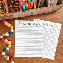 Load image into Gallery viewer, Colorful markers, crayons, and a Bible verse tracing worksheet on a wooden surface