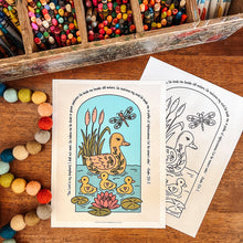 Load image into Gallery viewer, Two printable coloring/activity sheets featuring a duck family illustration with text, displayed on a wooden tabletop next to a box of colored pencils and bouncy beads.