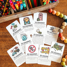 Load image into Gallery viewer, Educational cards about the U.S. Constitution on a wooden surface with markers and pencils.
