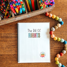 Load image into Gallery viewer, Notebook titled &#39;The Bill Of Rights&#39; on a wooden surface with colorful stationery items.
