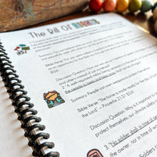 Load image into Gallery viewer, Notebook with Bill of Rights content and colorful beads on a wooden surface
