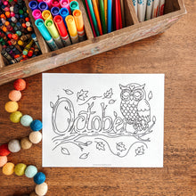 Load image into Gallery viewer, Coloring sheet with an owl and &#39;October&#39; text on a wooden table with art supplies.

