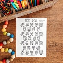 Load image into Gallery viewer, Colorful markers, pencils, and a worksheet with owl reading tracker on a wooden surface.
