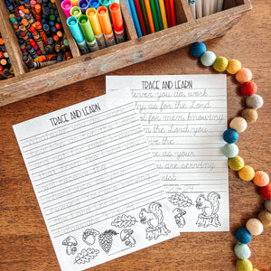 Colorful markers and Bible verse tracing page worksheet on a wooden surface