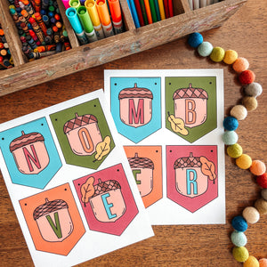 Colorful markers in a wooden box with November banner on a wooden surface