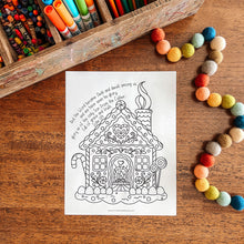 Load image into Gallery viewer, Coloring page of a gingerbread house with colored pencils and pom-poms on a wooden surface
