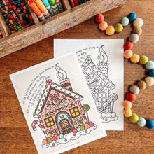 Load image into Gallery viewer, Coloring book with a gingerbread house design on a wooden table with art supplies.
