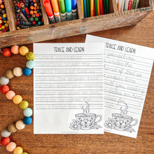 Load image into Gallery viewer, Colorful stationery items including crayons, markers, and colored pencils in a wooden box on a wooden surface with two 'Trace and Learn' Bible verse worksheets.
