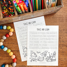 Load image into Gallery viewer, Colorful markers, crayons, and pencils in a wooden box with Bible verse tracing sheets on a wooden surface.
