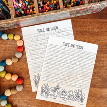 Load image into Gallery viewer, Two printed tracing sheets with lined writing space and black line drawings of a duck and reeds, placed on a wooden surface with colorful pencils and felt beads nearby.
