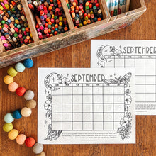 Load image into Gallery viewer, Two printable September calendar pages with moths and moon illustrations, arranged on a wooden table beside a wooden box of colorful pencils and pastel beads.
