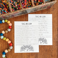 Load image into Gallery viewer, Two printable Bible verse tracing worksheet pages titled 'TRACE AND LEARN' laid on a wooden table, surrounded by colorful craft supplies including a wooden box of crayons and a string of round beads.
