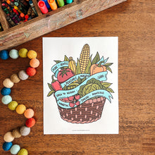 Load image into Gallery viewer, Colorful illustration of a basket with fruits and vegetables on a wooden surface with art supplies.
