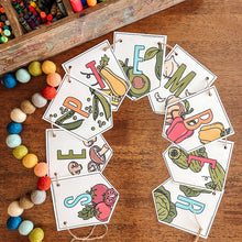 Load image into Gallery viewer, Colorful lSeptember banner with vegetable illustrations on a wooden surface with art supplies.
